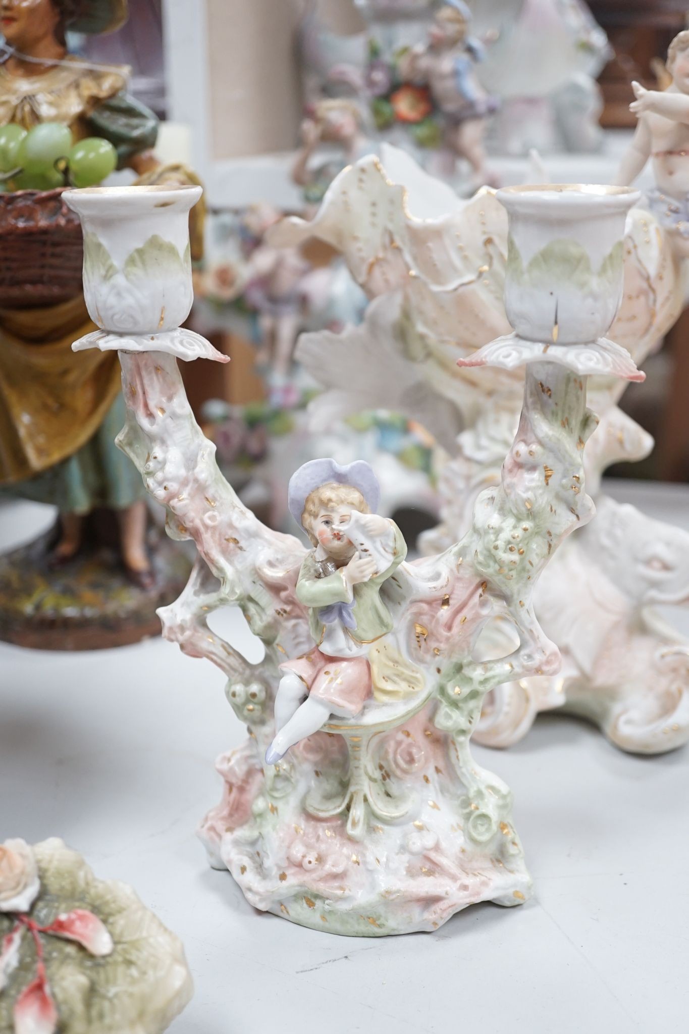 A group of Continental porcelain and pottery figural vases and centrepieces and two candelabra